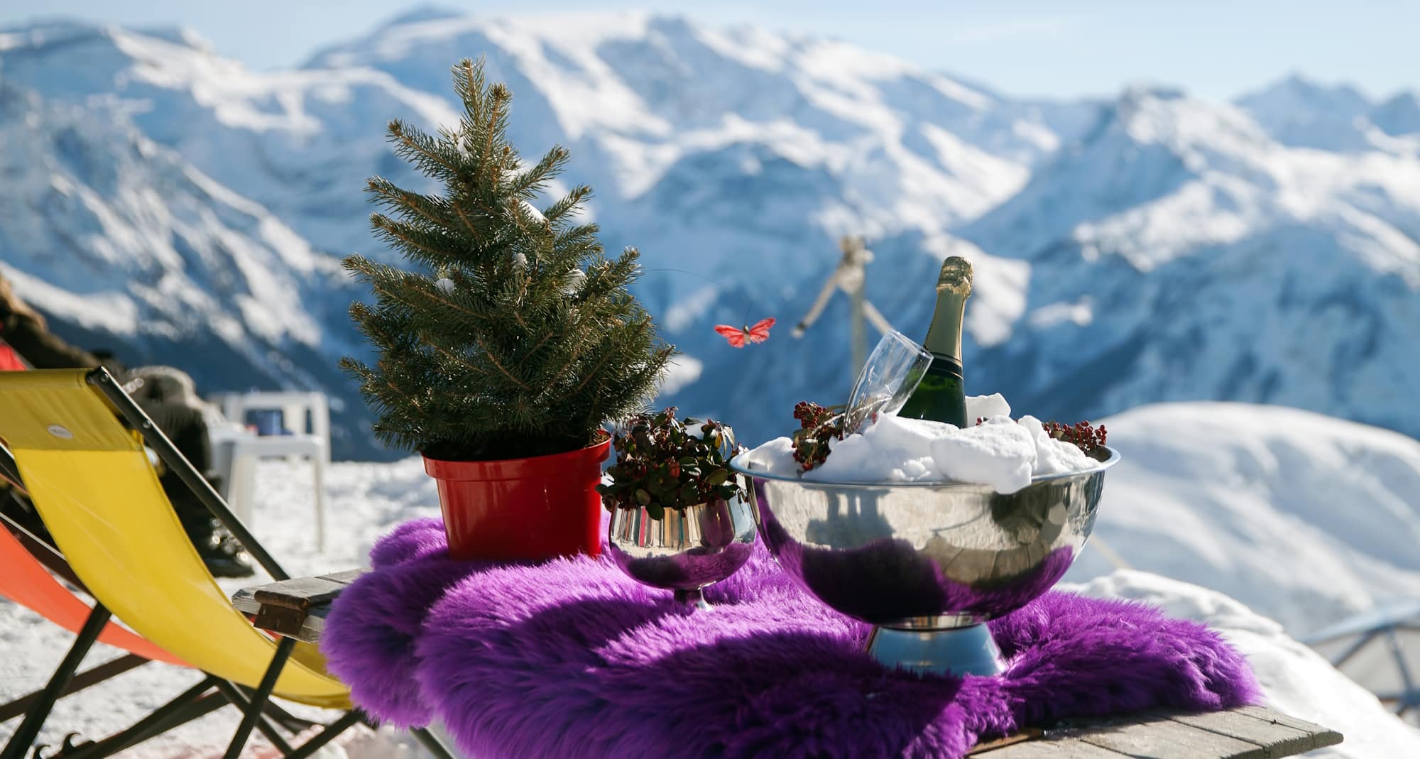  A bottle of champagne and a glass in ice on table in mountains, France © anrymos - stock.adobe.com 