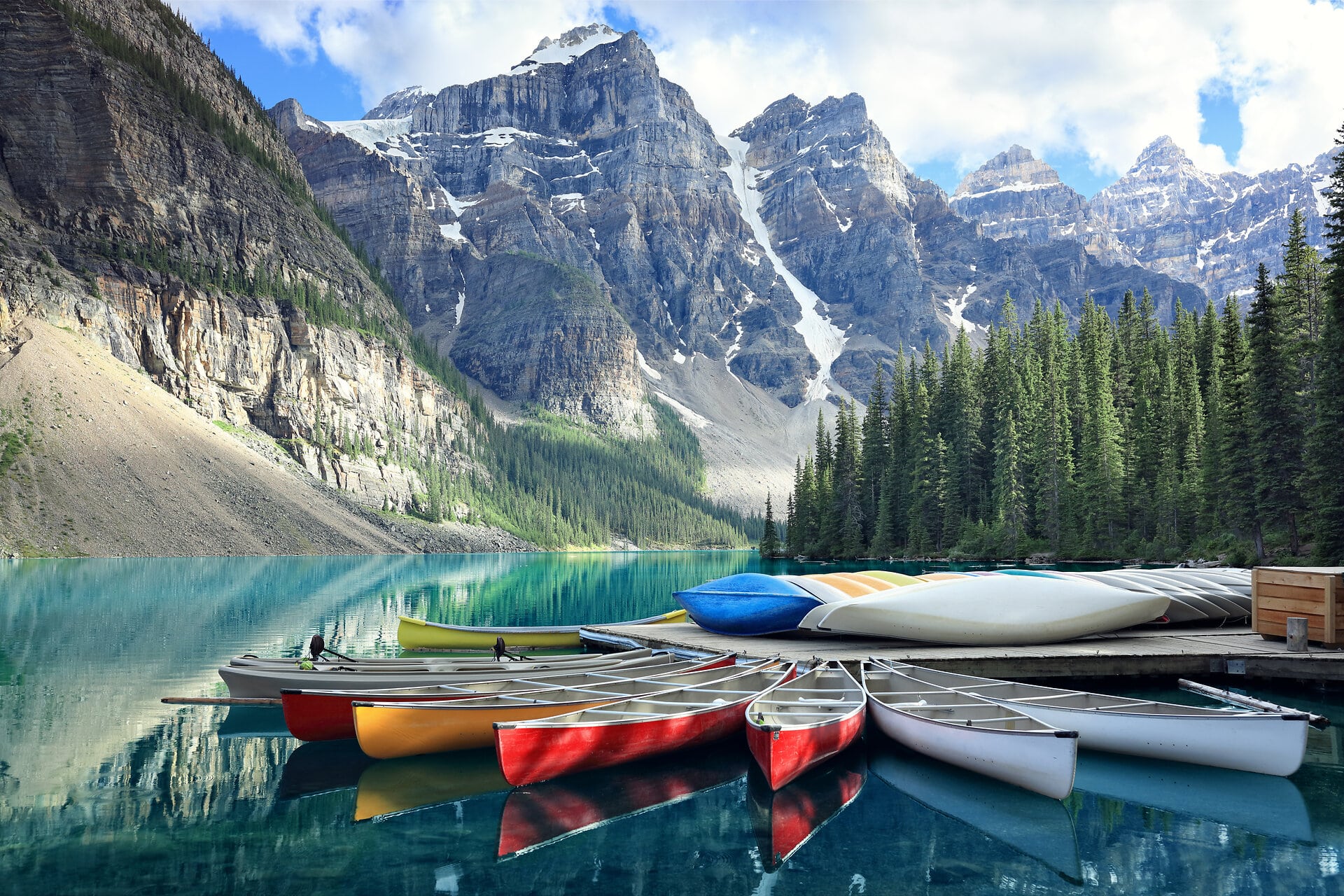 Canoes on a jetty at Moraine lake, Banff national park in the Rocky Mountains, Alberta, Canada